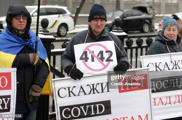 People attend a protest of opponents of vaccination against Covid-19 and quarantine measures in front of the Ukrainian Parliament in Kiev, Ukraine,...