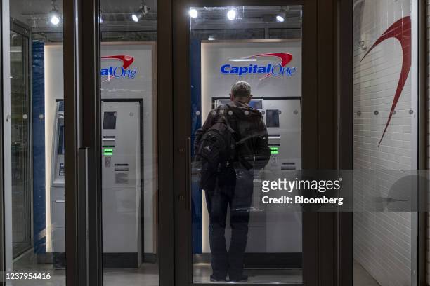 Customer uses an automated teller machine inside a Capital One cafe branch in San Francisco, California, U.S., on Thursday, Jan. 20, 2022. Capital...