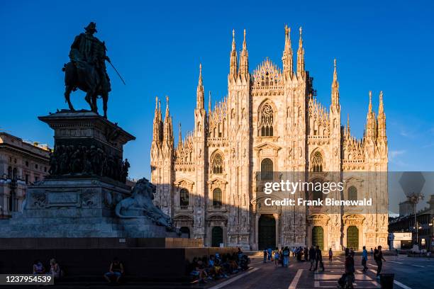 The equestrian statue of Vittorio Emanuele II facing the facade of the Milan cathedral, Duomo di Milano, seen from Cathedral Square, Piazza del Duomo.