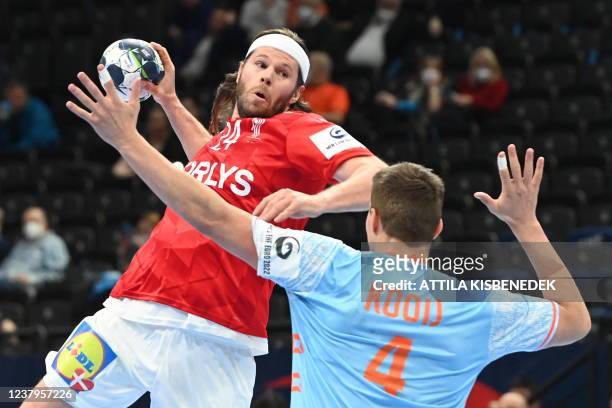 Denmark's Mikkel Hansen tries to score against Netherlands' Lars Kooij during the Men's European Handball Championship match between Denmark and the...