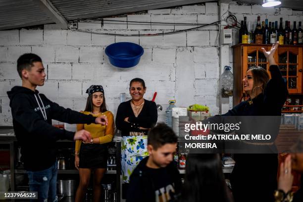 Marisa Rosa , 57 years old, the wife of the president of the Techari association, watches her daughter-in-law Aurea Fernandes , 24 years old, dancing...