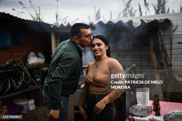 President of the Techari association Jose Fernandes , 58 years old, kisses his daughter Vanessa Fernandes, 31 years old, during a family lunch near...
