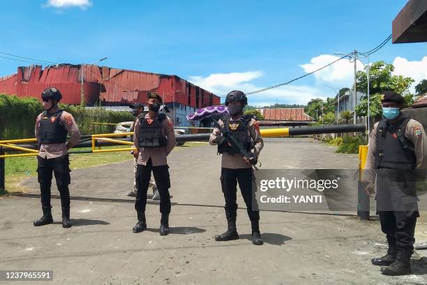 Police stand guard outside Double O nightclub where at least 18 people were killed in clashes between two groups, in Sorong in Indonesia's West Papua...