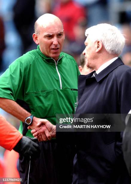 Referee Barry Knight shakes hands with Newcastle's manager Sir Bobby Robson 18 April 2004 in Birmingham. Knight had sent of Newcastle's Andrew...