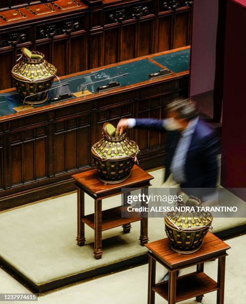 Member of the Italian parliament casts his ballot in the Italian parliament during a voting session as Italian Parliament votes for a new president...