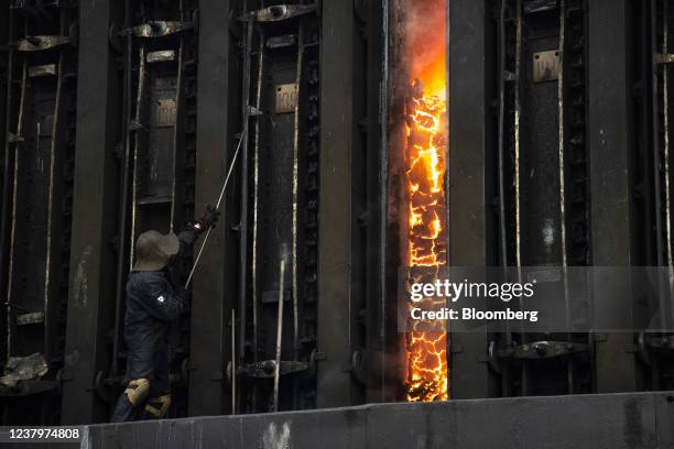 Worker handles a coke oven battery door at the Moscow coke and gas plant, operated by Mechel PJSC, in Vidnoye, near Moscow, Russia, on Monday, Jan....