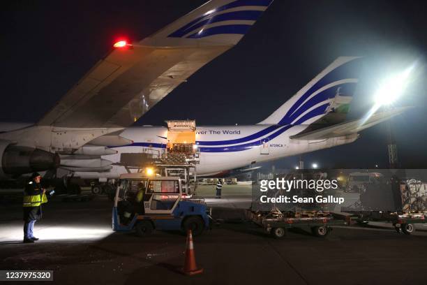 Ground crew unload weapons and other military hardware delivered by the United States military at Boryspil Airport near Kyiv on January 25, 2022 in...