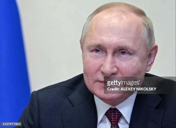 Russian President Vladimir Putin holds a meeting with members of Russia's national team ahead of the Beijing 2022 Winter Olympics, via a video...