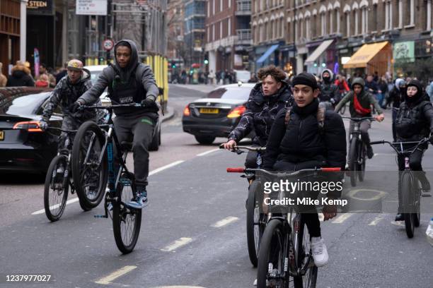 Group fo young cyclists on a mass ride-through wheelie their cycles around central London on 22nd January 2022 in London, United Kingdom. These...