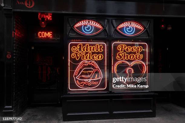 Neon signs for a peep show and adult video in Soho on 22nd January 2022 in London, United Kingdom. Soho has always been known as the seedy part of...