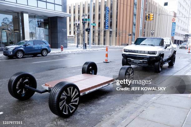 Battery pack and GM's new Hummer EV stand outside an event where General Motors announced an investment of more than $7 billion in four Michigan...