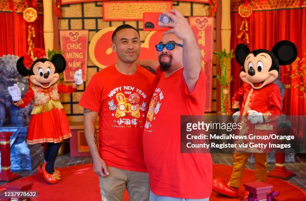 Anaheim, CA Brothers Jeff Morris, left, and Ben Morris, take a selfie with Mickey and Minnie during Lunar New Year in California Adventure at the...