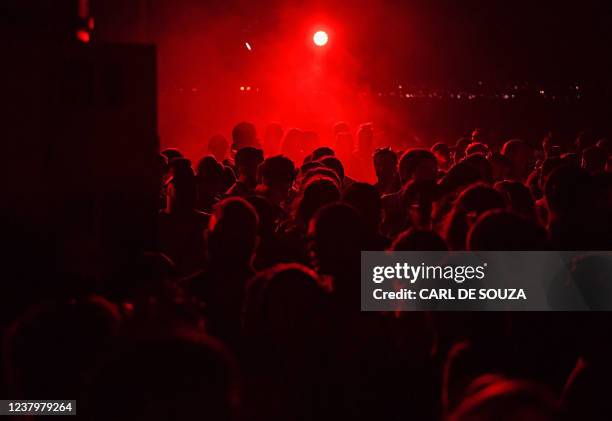 People are seen during an electronic music event by French broadcasting group Cercle in Rio de Janeiro, Brazil, on January 24, 2022. - Thousands of...