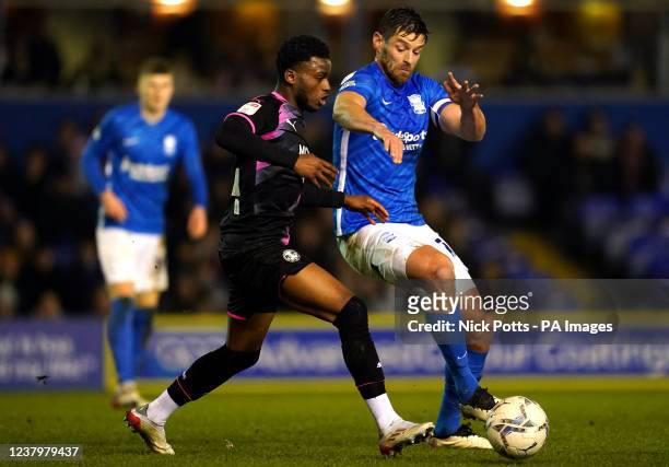 Peterborough United's Bali Mumba and Birmingham City's Lukas Jutkiewicz during the Sky Bet Championship match at St. Andrew's, Birmingham. Picture...