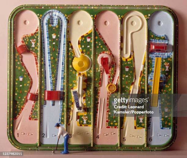 Vintage metal mini-golf game, arranged on a tray, produced in Germany, circa 1920.