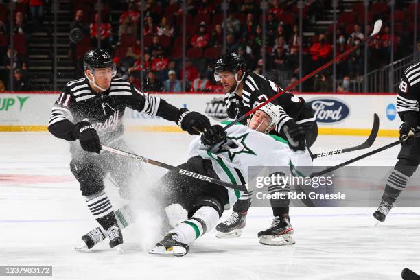 Jacob Peterson of the Dallas Stars collides with Andreas Johnsson of the New Jersey Devils during the first period on January 25, 2022 at the...