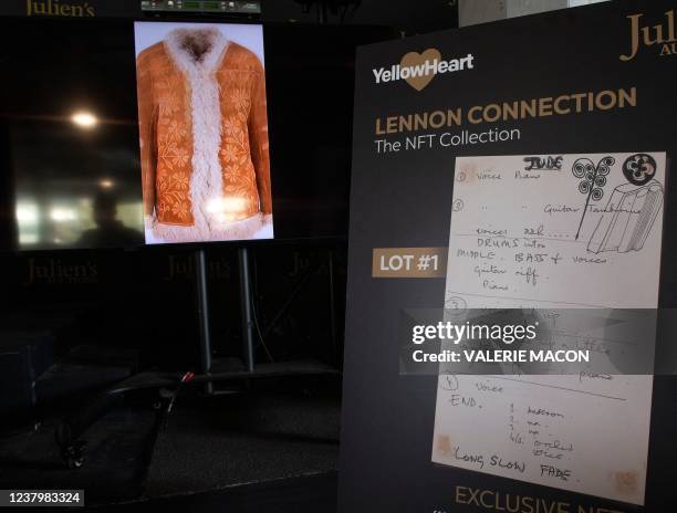 Of John Lennon's "Magical Mystery Tour" Afghan coat and a print of "Hey Jude" notes written by Paul McCartney are seen during the media preview of...