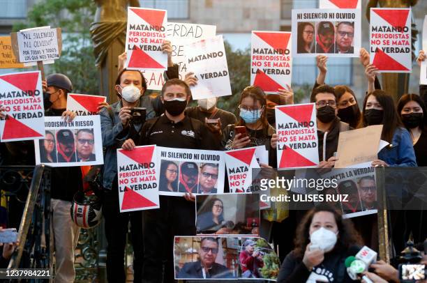 Group of journalists hold posters that read "The killing of periodists doesn't kill the truth" during a demonstration against violence against...