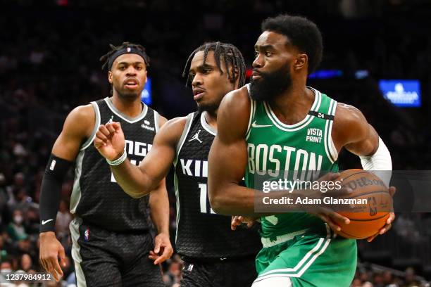 Jaylen Brown of the Boston Celtics goes to the basket past Davion Mitchell of the Sacramento Kings during a game at TD Garden on January 25, 2022 in...