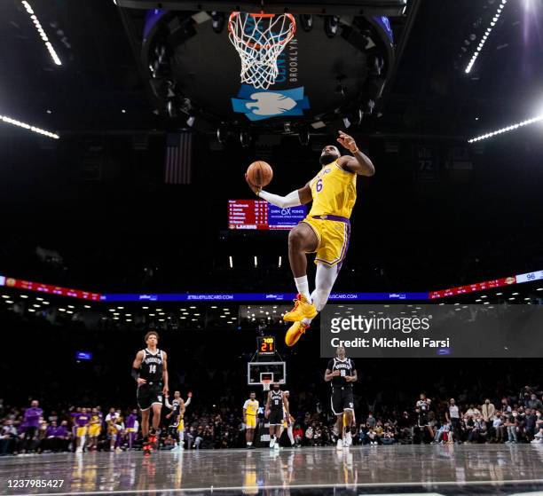 LeBron James of the Los Angeles Lakers dunks against the Brooklyn Nets at Barclays Center on January 25, 2022 in the Brooklyn borough of New York...
