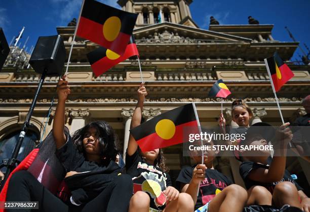 Youths and children wave the Australian aboriginal flag as protesters take part in an "Invasion Day" demonstration on Australia Day in Sydney on...