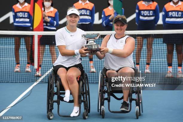 Netherlands' Diede de Groot and Netherlands' Aniek van Koot pose with the trophy after winning against Japan's Yui Kamiji and Britain's Lucy Shuker...