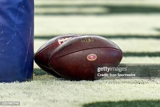 Detail view of a San Francisco 49ers logo is seen on a football resting on the field during the NFC Wild Card game between the San Francisco 49ers...