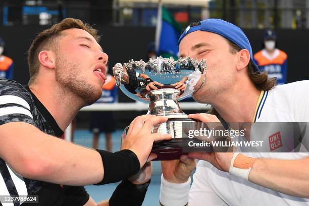 Britain's Gordon Reid and Britain's Alfie Hewett celebrate with the trophy after winning their men's wheelchair doubles final match against Japan's...