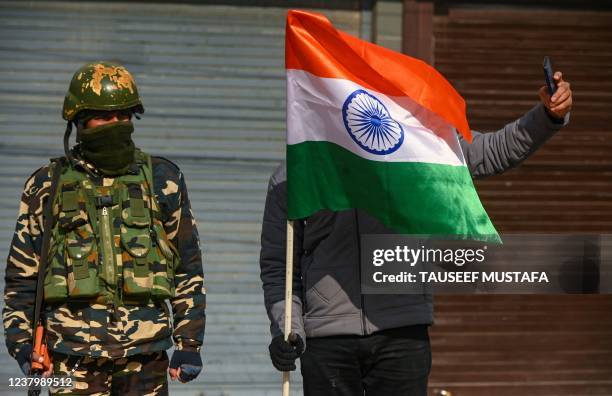 Bhartiya Janta Party activist holding an Indian flag takes picture as BJP activists gather to celebrate India's 73rd Republic Day at the clock tower...