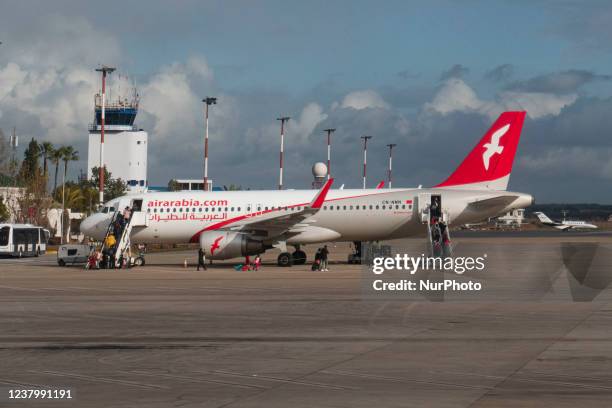 Air Arabia Maroc Airbus A320 aircraft as seen at Fes - Sais Airport near the city of Fez while passenger are seen boarding the plane. The Airbus jet...