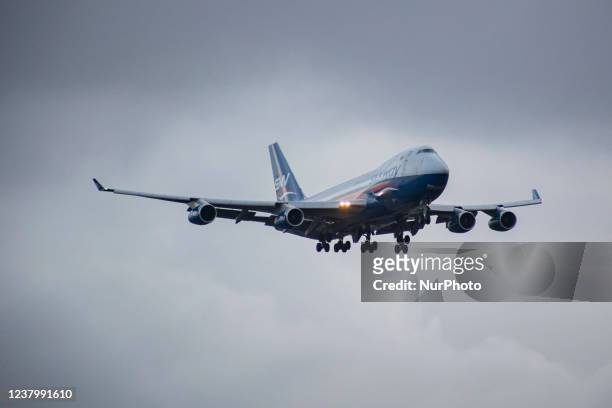 Silk Way West Airlines Jumbo Jet Boeing 747-400F freight edition cargo aircraft as seen flying and landing at Amsterdam Schiphol Airport AMS EHAM...