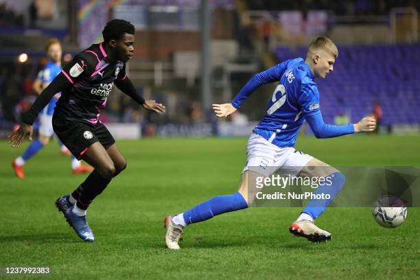 Jordan James of Birmingham City runs with the ball followed by Bali Mumba of Peterborough United during the Sky Bet Championship match between...