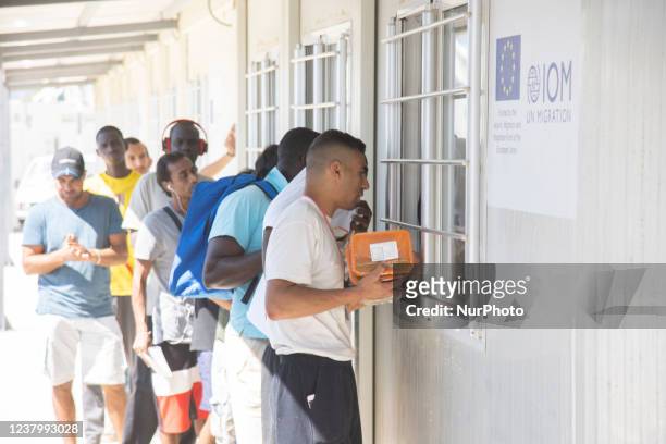 People wait in line to receive the lunch food distribution. Inside the new Refugee camp in Samos island that has been created in Greece with the...