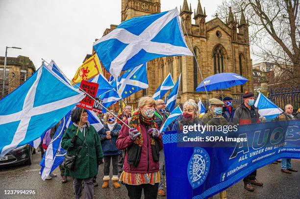 During the demonstration, protesters are seen marching on a street while holding flags and a banner saying 'AUOB - ALL UNDER ONE BANNER'. A thousand...