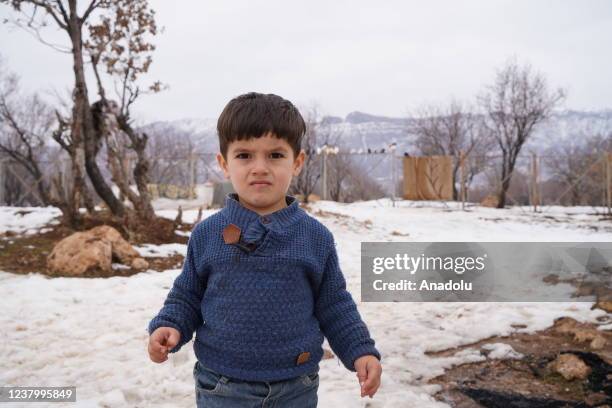 Kid is seen as Yazidi refugee families living in Dawodiya camp struggle amid freezing temperatures and harsh living conditions in Duhok, Iraq on...