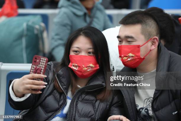 Mask-clad couple selfie at a railway station in Nantong in east Chinas Jiangsu province Monday, Jan. 24 a week ahead of the Spring Festival.