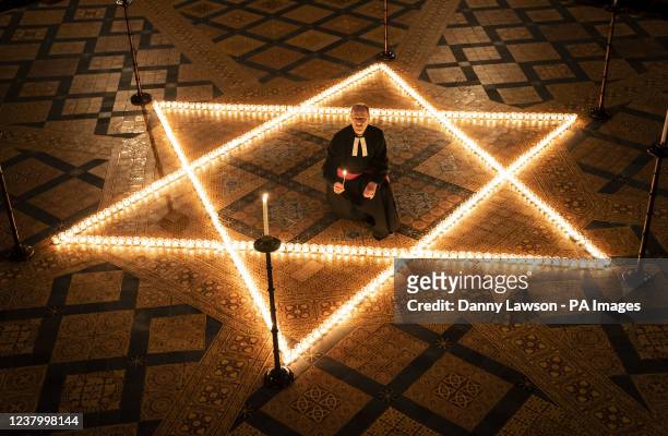 The Reverend Canon Michael Smith, Acting Dean of York, helps light six hundred candles in the shape of the Star of David, in memory of more than 6...