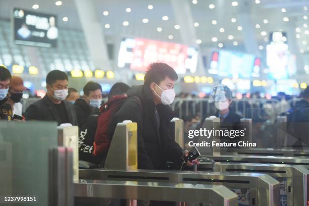 Passengers line up at a boarding gate at a railway station in Hangzhou in east Chinas Zhejiang province Tuesday, Jan. 25 as the Spring Festival comes...