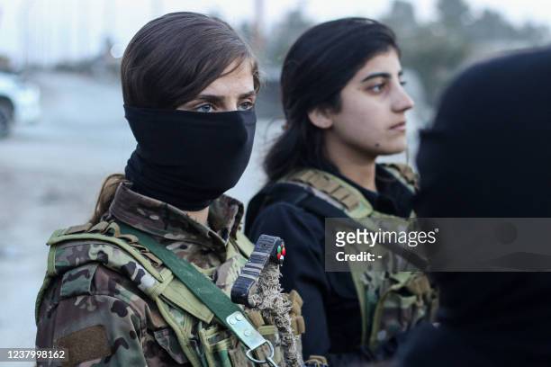 Female members of the Syrian Democratic Forces deploy outside Ghwayran prison in Syria's northeastern city of Hasakeh on January 26 after having...