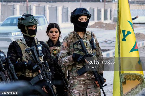 Female members of the Syrian Democratic Forces deploy outside Ghwayran prison in Syria's northeastern city of Hasakeh on January 26 after having...