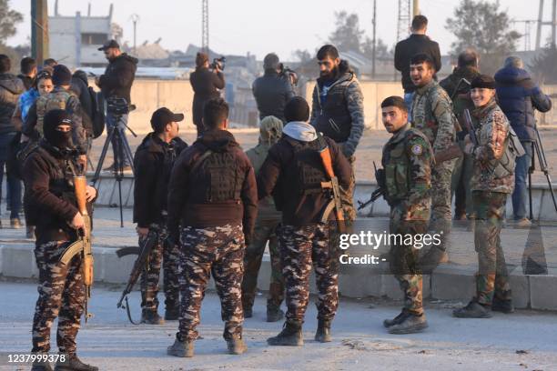 Members of the Syrian Democratic Forces deploy outside Ghwayran prison in Syria's northeastern city of Hasakeh on January 26 after having declared...