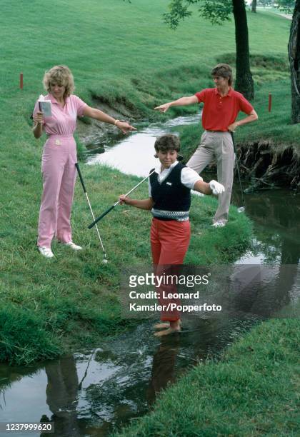 Lady professional golfers, left to right, Jan Stephenson, Hollis Stacey and Beth Daniel, trying to interpret a golf Rule Book, circa 1986.