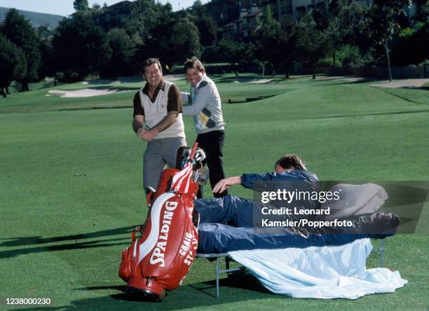 Left to right, Fuzzy Zoeller, Lanny Wadkins and Craig Stadler , enacting a "slow play" scenario with Stadler rising from a camp bed on the fairway...