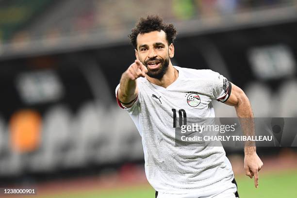 Egypt's forward Mohamed Salah celebrates after winning the Africa Cup of Nations 2021 round of 16 football match between Ivory Coast and Egypt at...