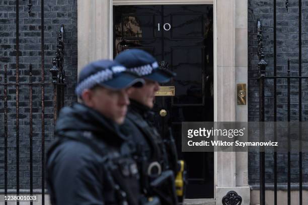 Police officers walk in front of 10 Downing Street on January 26, 2022 in London, England. The findings from Sue Gray's inquiry into several alleged...