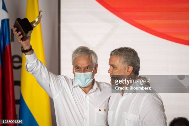 Sebastian Pinera, Chile's president, left, receives a gift from Ivan Duque, Colombia's president, during the XVI Presidential Summit of the Pacific...