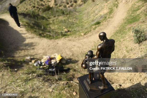 Bronze sculpture by artist Dan Medina, depicting Kobe Bryant, daughter Gianna Bryant, and the names of those who died, is displayed as a one-day...