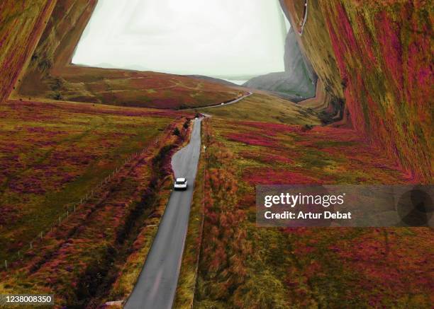 surreal aerial view driving in scotland bending the landscape with stunning colors creating tunnel effect. - skye stockfoto's en -beelden