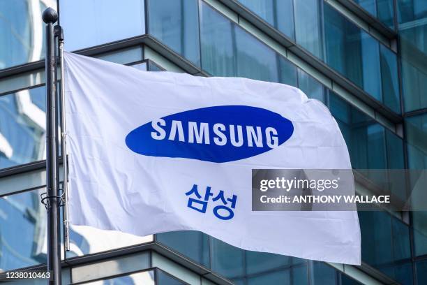 Samsung flag is seen hoisted outside the company's Seocho building in Seoul on January 27, 2022.