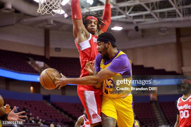 Mason Jones of the South Bay Lakers passes the ball around Freddie Gillespie of the Memphis Hustle during an NBA G-League game on January 26, 2022 at...